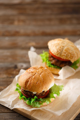 Homemade hamburgers and french fries on wooden table