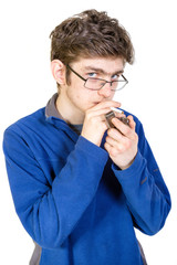 Teenage boy lighting a cigarette