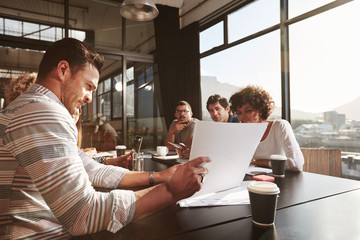 Businessman explaining business plan to his colleagues
