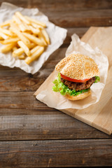 Homemade hamburgers and french fries on wooden table