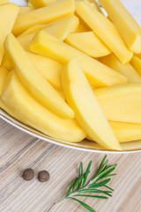 Raw sliced potatoes in a plate.