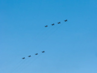 8 Mikoyan-Gurevich MiG-31 (Foxhound) supersonic interceptor aircrafts fly on blue sky background
