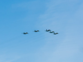 5 Su-25SM (Frogfoot) jet aircrafts fly on blue sky background
