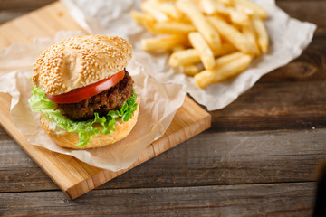 Homemade hamburgers and french fries on wooden table