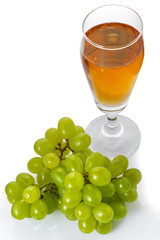 Glass of white wine and grapes isolated on white background