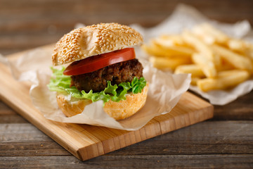 Homemade hamburgers and french fries on wooden table