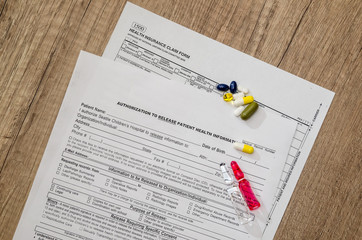 Prescription form lying on table with pills and  syringes