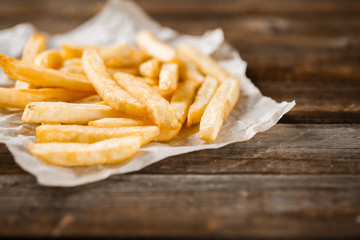 French fries on wooden table.