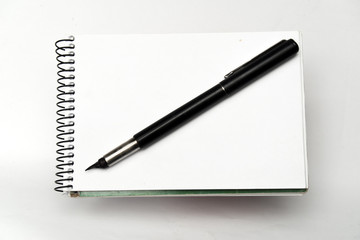 black pen on notebook on white background