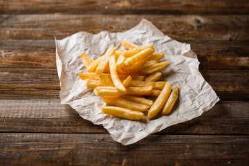 French fries on wooden table.