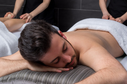 Young man enjoying massage with girlfriend.