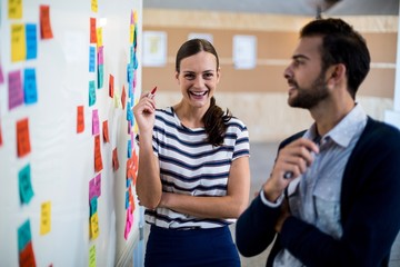 Colleagues looking at white board