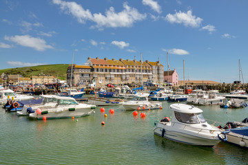 Fototapeta na wymiar fishing boats and yachts in West Bay harbor West Bay, Dorset, England