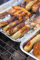 Grilled sausage and turkey on the foil dish is grilled.