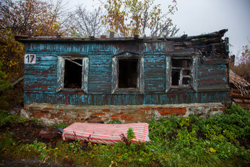facade of old building collapsing Russian peasant house