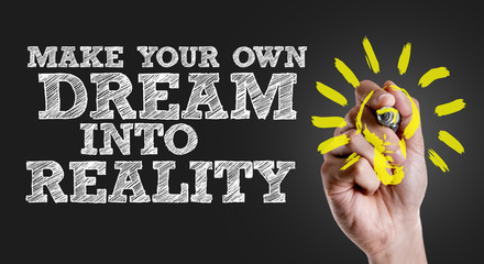 Hand writing the text: Make Your Own Dream Into Reality