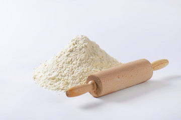 Pile of wheat flour and rolling pin