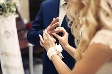 wedding ceremony of stylish elegant blonde bride and groom putti