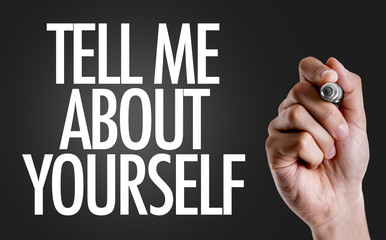 Hand writing the text: Tell Me About Yourself