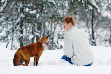 Beautiful girl with red fox on walk