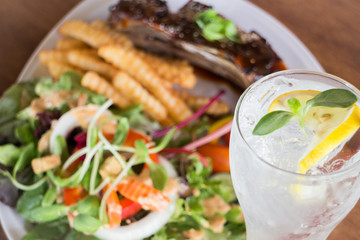 Delicious barbecued ribs and lemon soda drink