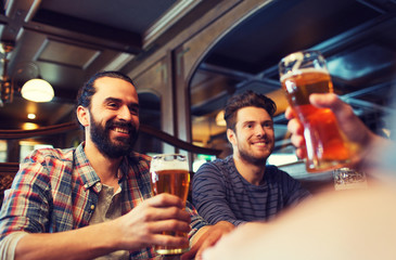 happy male friends drinking beer at bar or pub