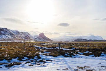 Mountain and Field covered with some snow during winter in Iceland