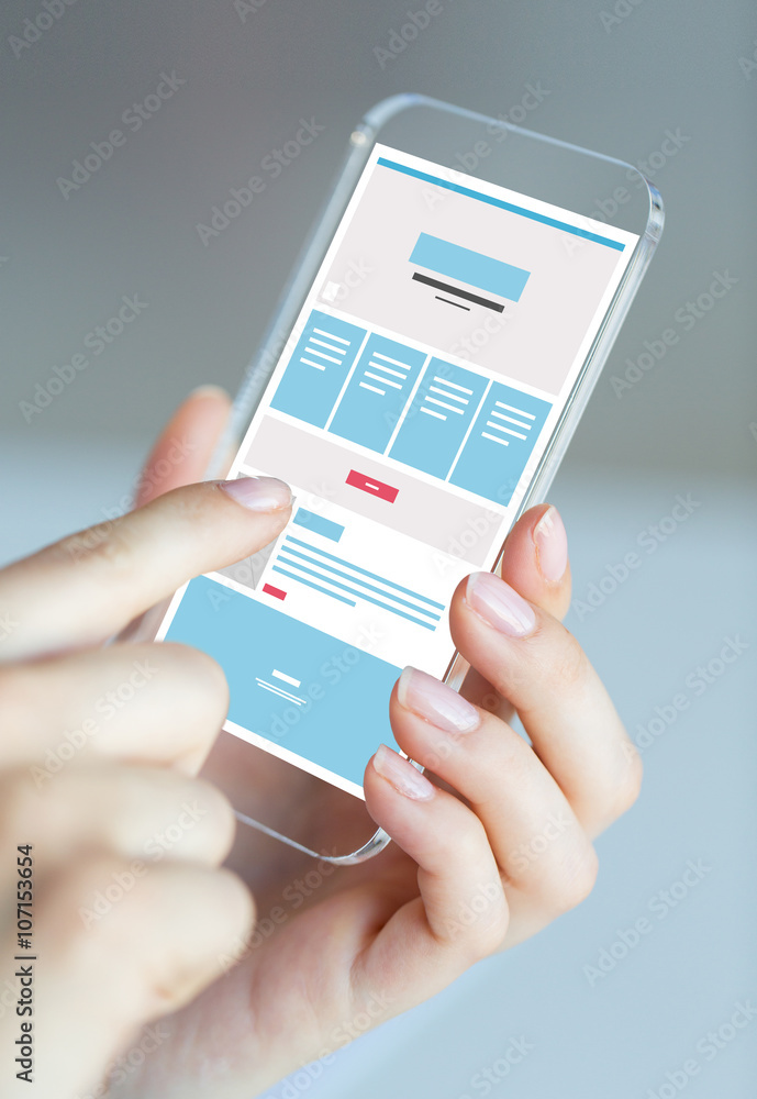 Wall mural close up of hands with web design on smartphone