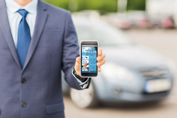 close up of business man with smartphone and car