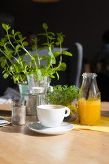 Bottle of Freshly squeezed orange juice sitting on a rustic wooden table.