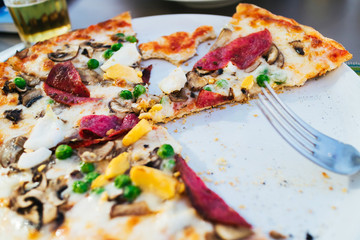 Sliced pizza with different ingredients