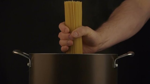 Throwing the spagetti into the cooking pot