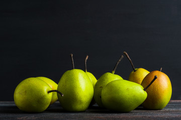 Fresh pears on a rustic wooden background