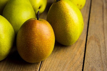 Fresh pears on a rustic wooden background