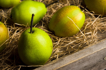 Fresh pears on a rustic wooden background