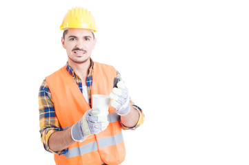 Young builder or constructor holding a cup of hot coffee