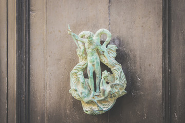 Old Metal Poseidon Shaped Knocker on Wooden Door in Mdina, Malta