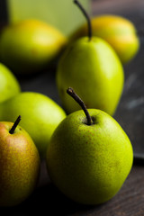 Fresh pears on a rustic wooden background