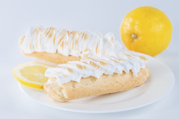 delicious eclair on a plate and lemon