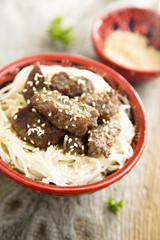 Fried beef with noodles and sesame seeds