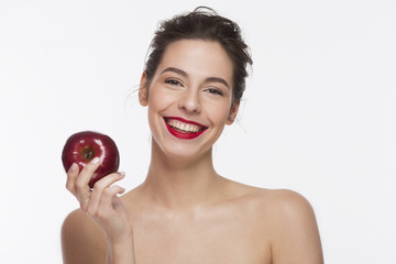 Young beautiful sexy girl with dark hair, red lipstick holding big red apple. Isolated