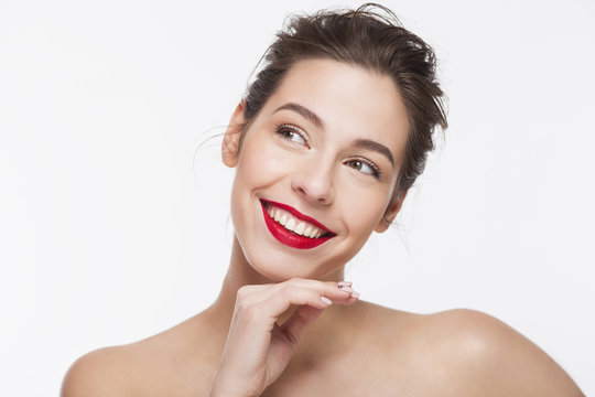 Image of a smiling beautiful girl with red lipstick over white background.