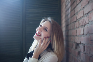 Fototapeta premium Portrait of a beautiful girl talking on the phone