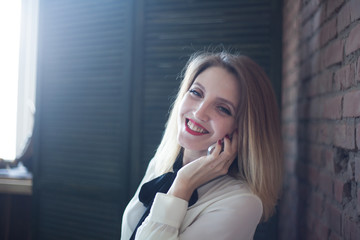 Fototapeta premium Portrait of a beautiful girl talking on the phone