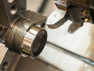 operator machining mold and die part by CNC turning machine in f