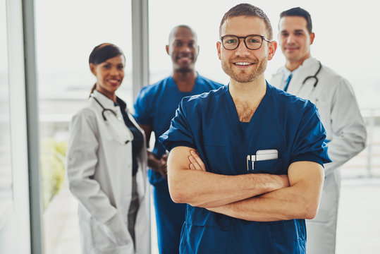Confident doctor in front of group