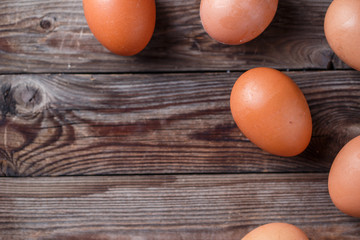Brown eggs on a rustic wooden table