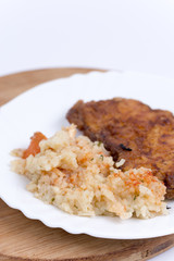 Breaded meat with cooked rice with vegetables