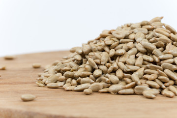 Pile of sunflower seeds on the wooden board