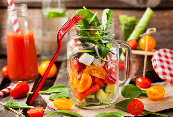 Fresh healthy vegetable salad in glass jar